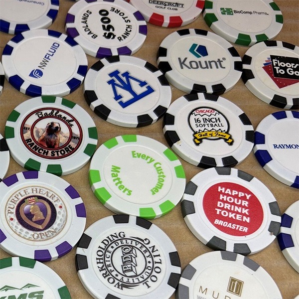 Promotional poker chips featuring assorted custom logos, messages and branding