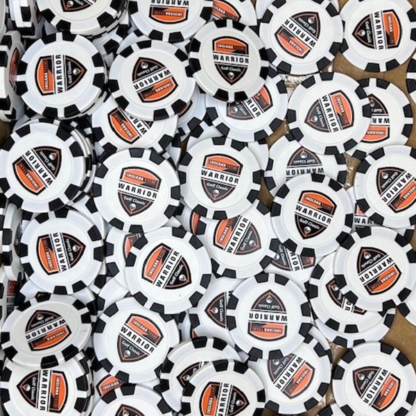 Black and white promotional poker chips featuring an orange custom logo