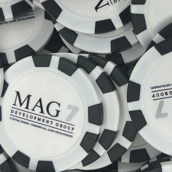Black and white personalized poker chips featuring a custom business logo
