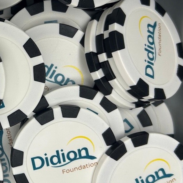 Black and white custom poker chips printed with a foundation logo