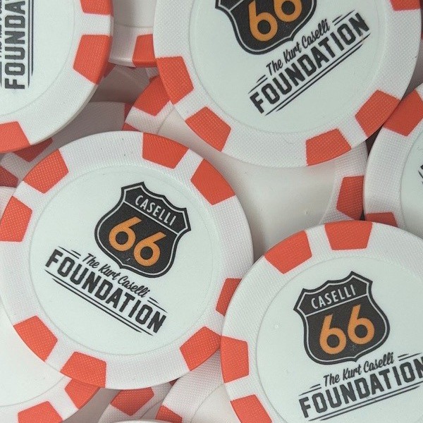 Orange and white personalized poker chips with a highway shield logo