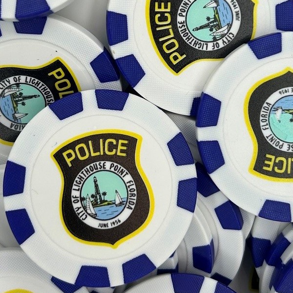 Blue promotional poker chips printed with a full-color police department badge