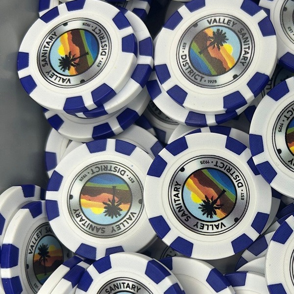 Blue and white custom poker chips with a full-color district logo