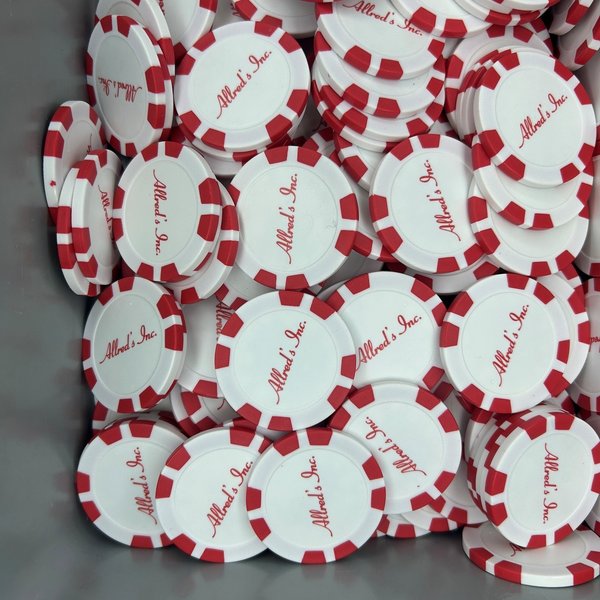 Red and white personalized poker chips printed with a script logo
