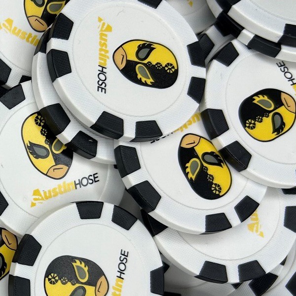 Black and white custom poker chips with a yellow company logo