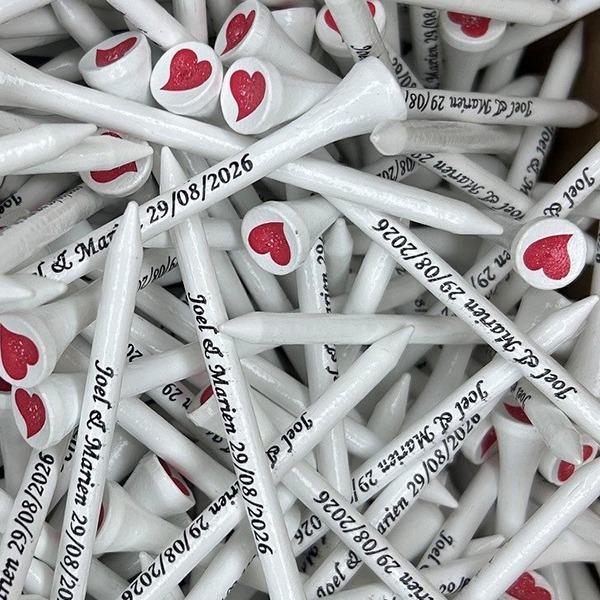 White custom golf tees with a red heart cup imprint and wedding date